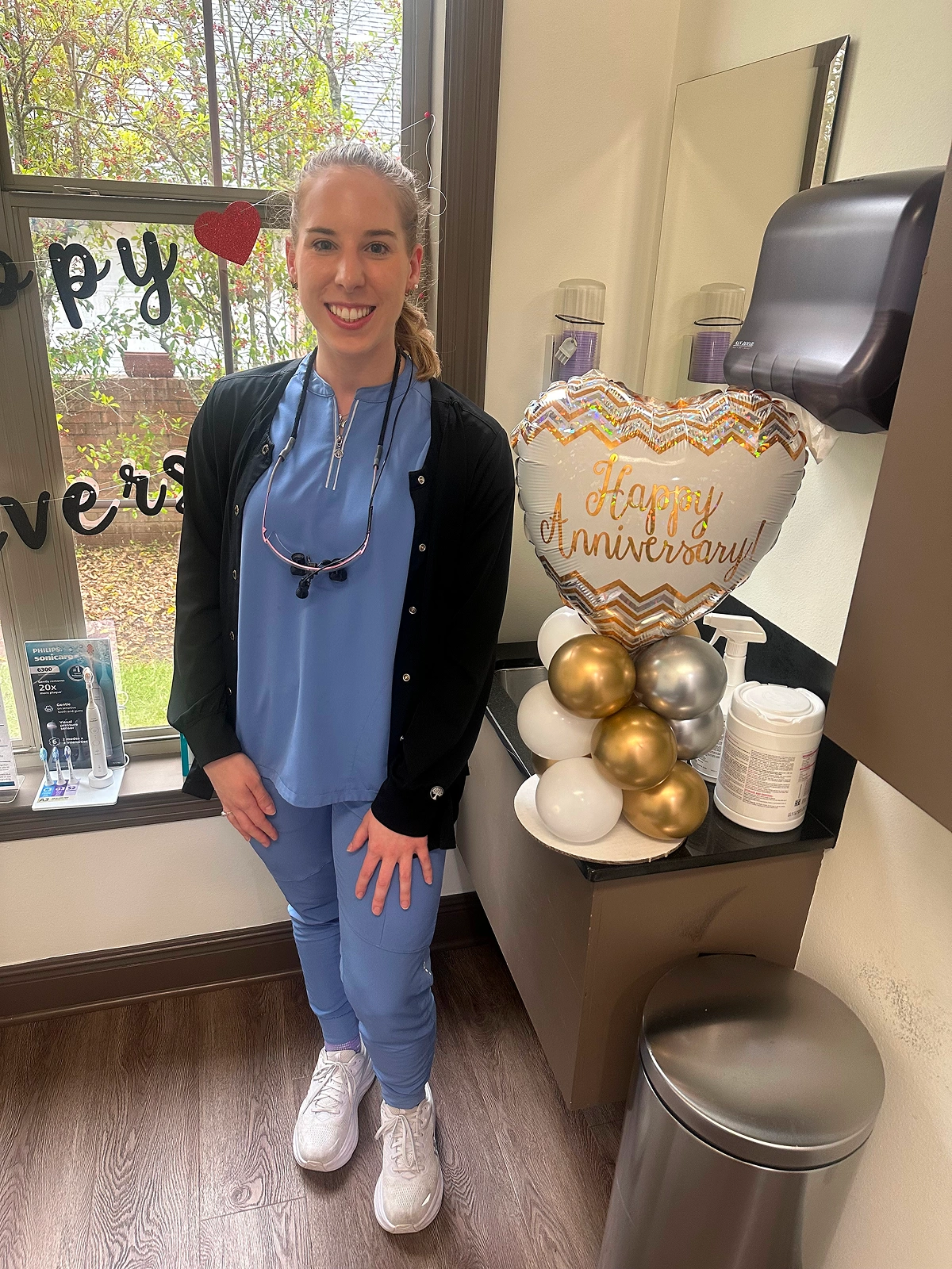 A female healthcare provider holding a gift basket in an office