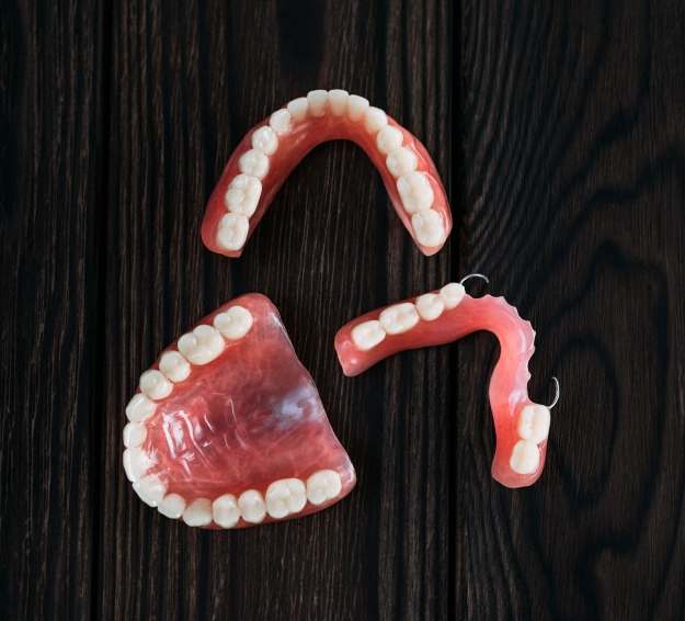 Full and partial dentures displayed against a dark background