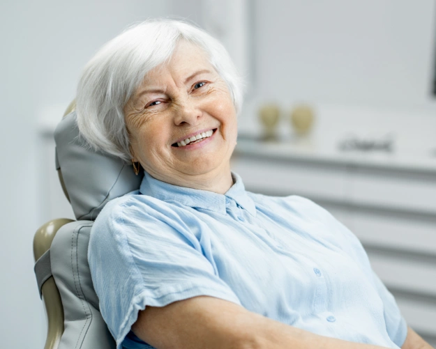 Older woman receiving root canal treatment in a dental office