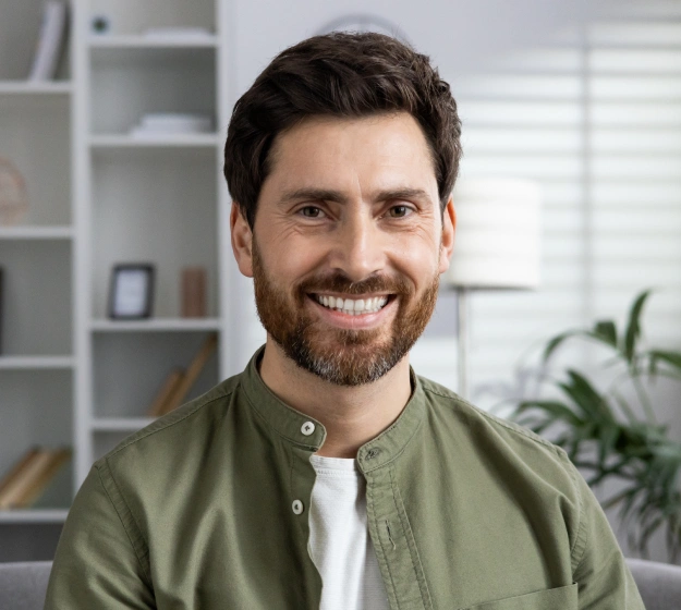 Man smiling and showing his teeth after a teeth whitening treatment