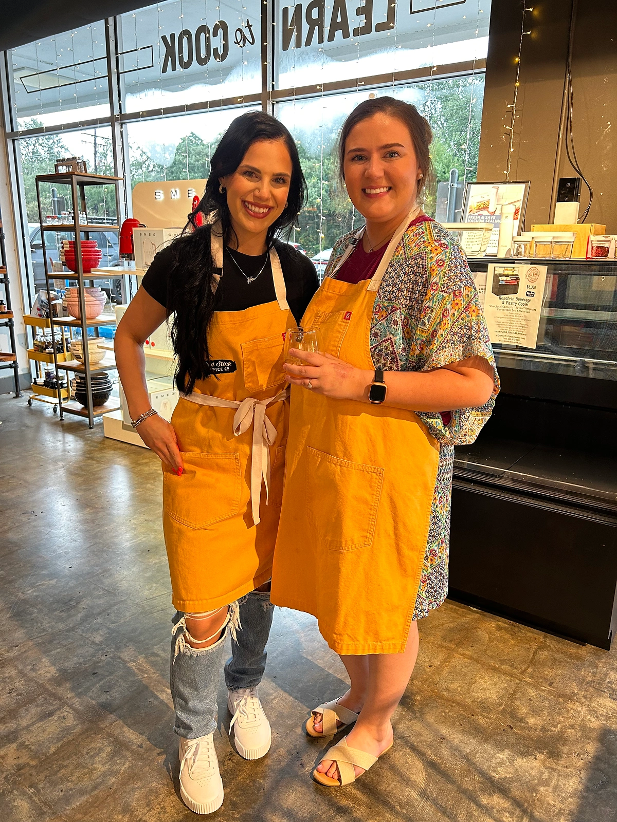 Two team members posing together while preparing food