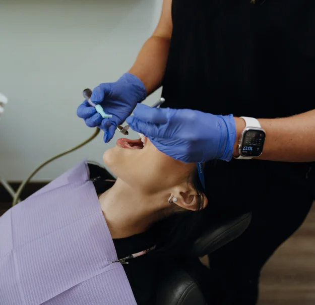 Woman receiving dental cleaning and examination