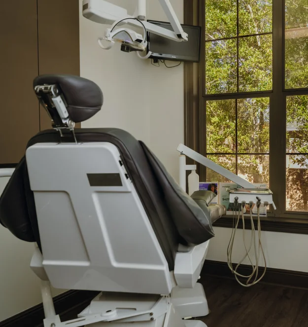 A modern dental chair and equipment in a dental treatment room