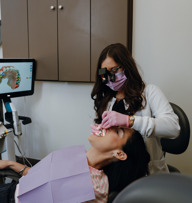 A dentist performing restorative dental treatment on a patient in a dental clinic